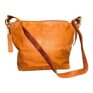 Leather hand tooled shoulder bag with brass hardware. Huge interior. P 13